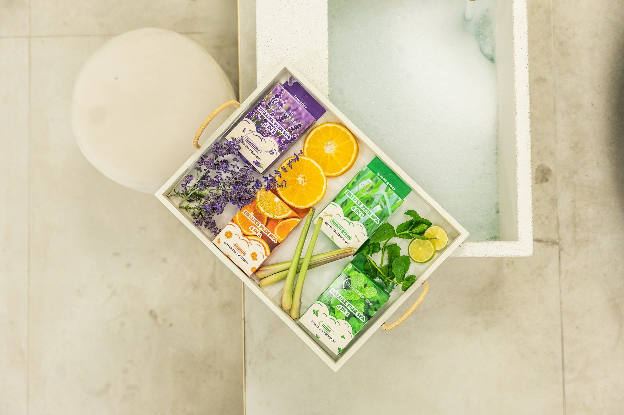 A spa pedicure tray with citrus slices and lavender