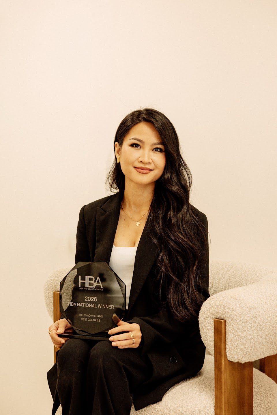 Sunny Williams seated with her award