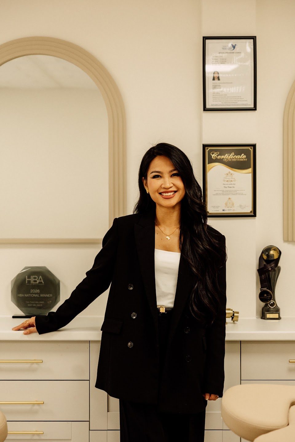 Sunny Williams standing in the Suukkosan studio beside her awards